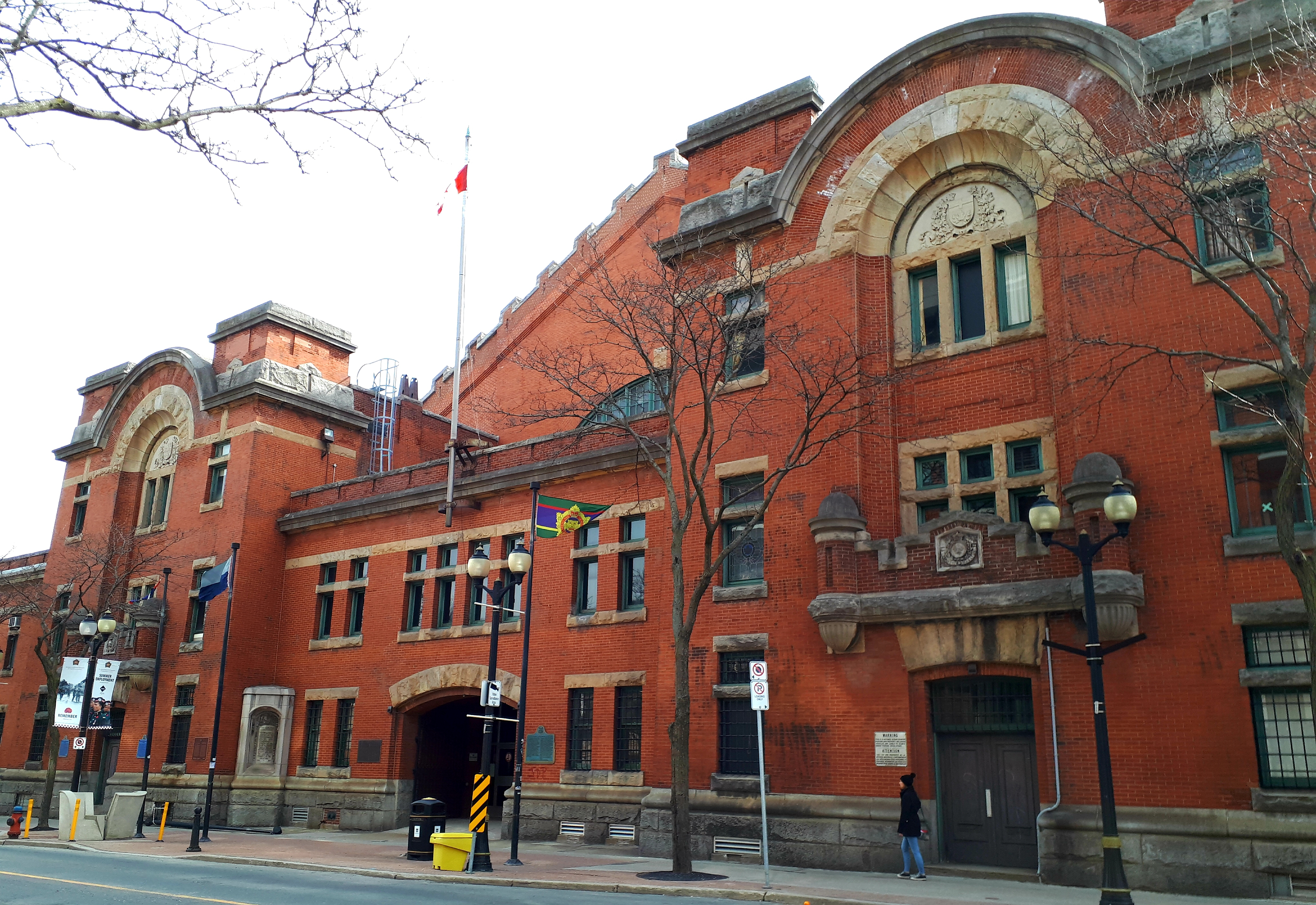 The John Weir Foote Armoury National Historic Site, in Hamilton, Ontario, seen from James St. North. The Armoury is an imposing red brick building, with decorative arch and stone details.